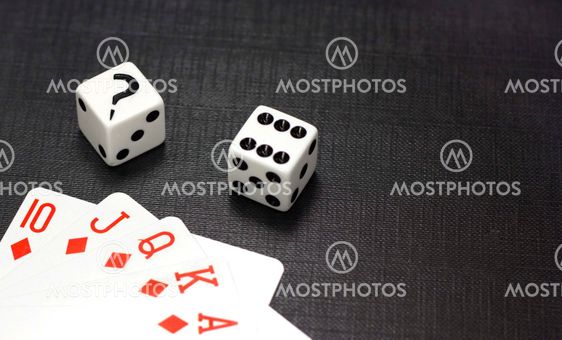 Dices and playing cards on a black background