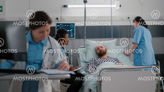Medical practitioner doctors checking sick man analyzing...