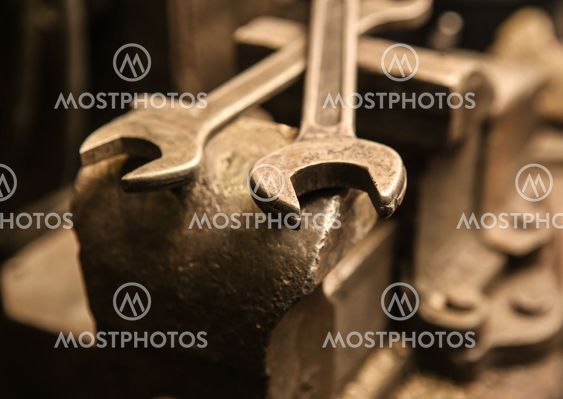 old metal vice and wrenches