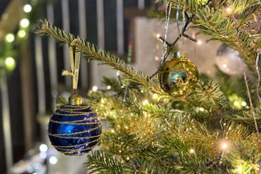 Christmas decorations, one blue ball hanging on...