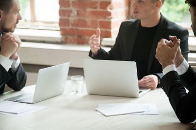 Partners negotiating with client about developing...