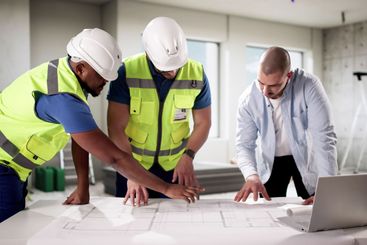 Diverse group of professionals inspecting house interior...