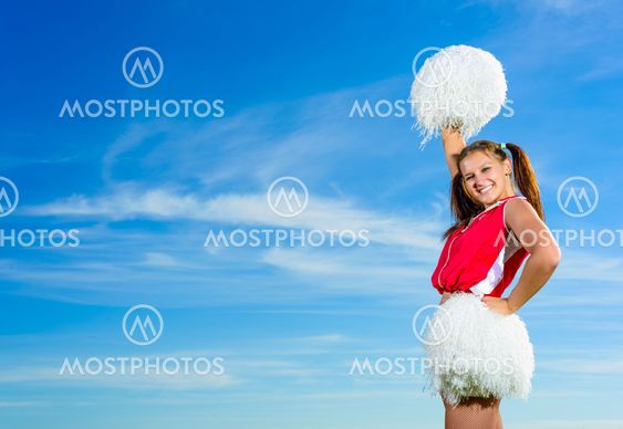 Young cheerleader in red costume with pampon