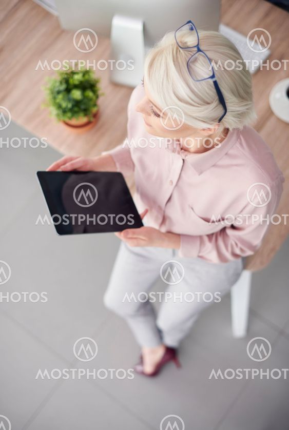 Overhead view of entrepreneur with tablet leaning against...