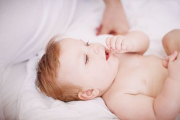 Baby, parent and playing with hands in home, love and...