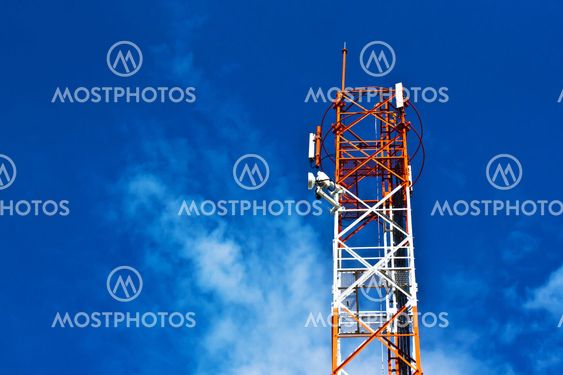 communication antennas, radio telephone mobile phone antennas on blue sky background