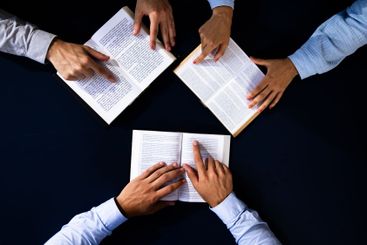 Christian Preacher Reading Holy Bible With Friends in...