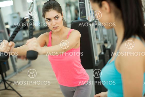 Pretty young women training in the gym