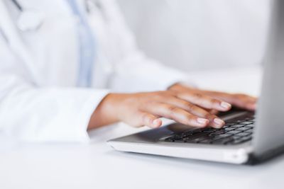 female doctor using her laptop computer