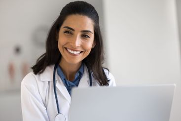 Portrait happy smiling young beautiful female physician...