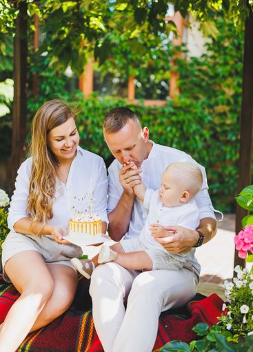 Mom and dad in nature with their one-year-old son...