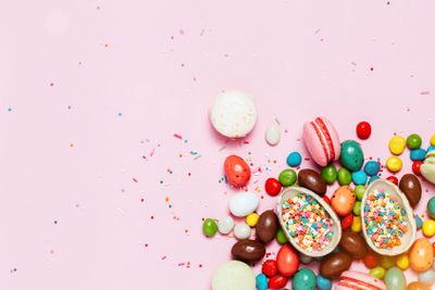 Easter frame made from colorful eggs and big chocolate...