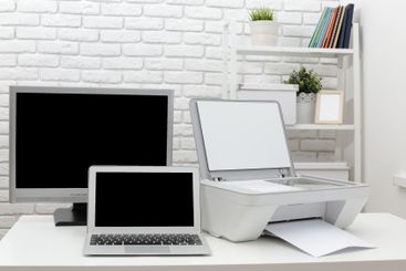 Home office workspace with computer, printer, and modern...