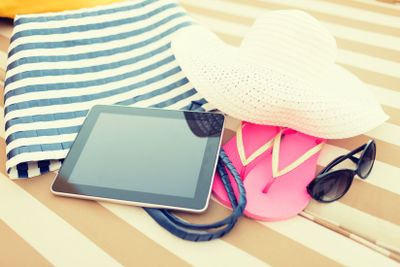 close up of tablet pc on beach