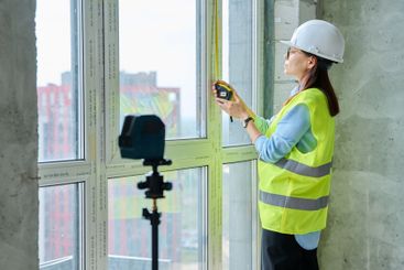 Industrial worker, woman measuring window with tape...