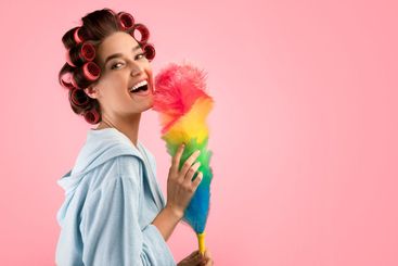 Happy Woman With Hair Curlers Holding Feather Duster,...