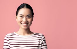 Portrait of positive attractive young asian woman posing...