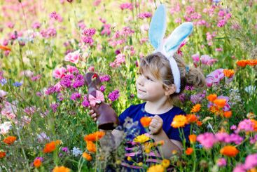 Portriat of adorable, charming toddler girl with Easter...