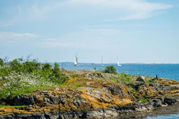 scenic coastal view with rocks and boats.