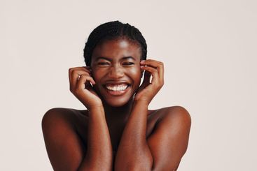 Skincare, happy and black woman in studio with natural,...
