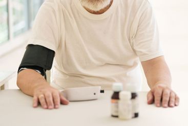 Senior man measuring blood pressure