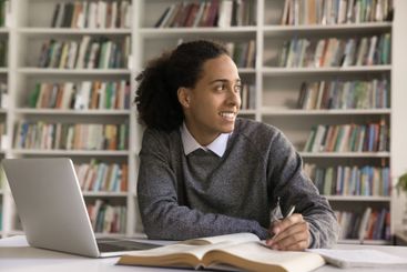 Teenage male learning at library look aside distracted...