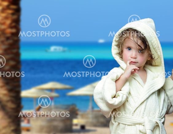 cute girl in bathrobe on beach