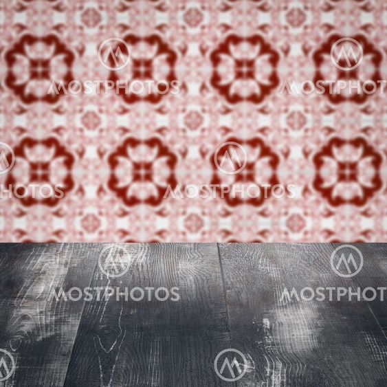 Wood table top and blur vintage ceramic tile pattern wall