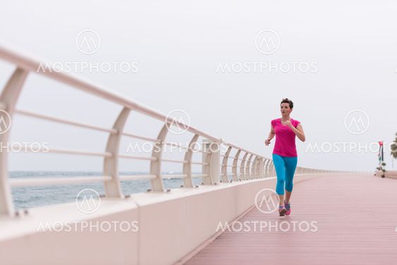 woman busy running on the promenade