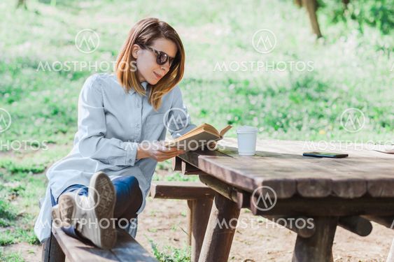 Woman reading a book in the park