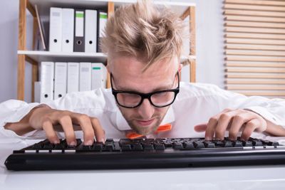 Concentrating Businessman Typing On Keyboard