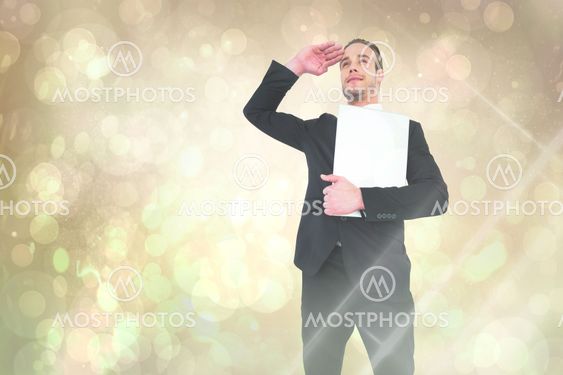 Composite image of smiling businessman looking and holding laptop