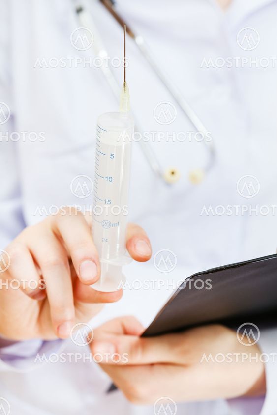 nurse holds syringe and clipboard