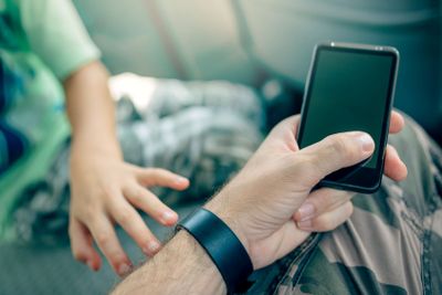 Playing with mobile phone instead of child