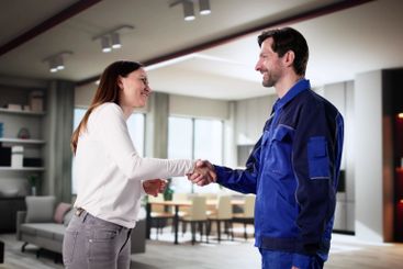 Plumber and Handyman Chatting About Home Repairs