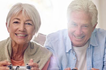 Video game, smile and senior couple play together for...