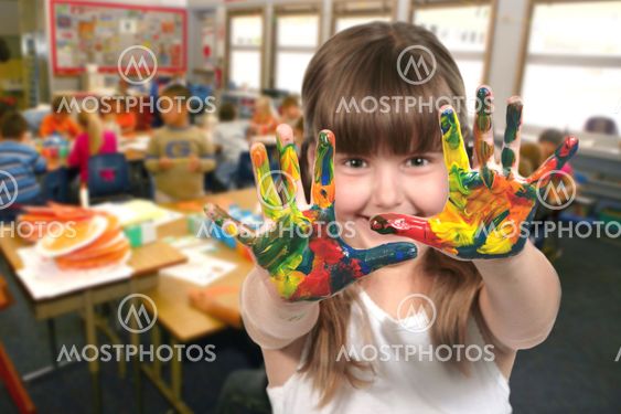 School Age Child Painting With Her Hands in Class