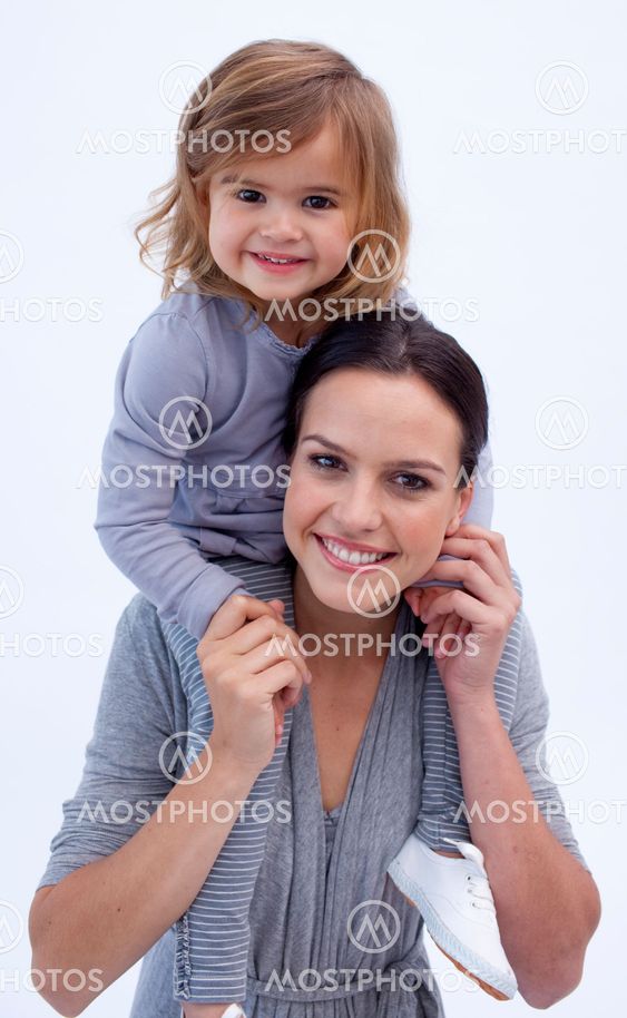Mother giving her daughter piggyback ride