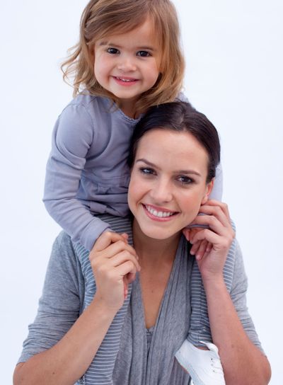 Mother giving her daughter piggyback ride