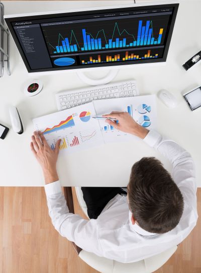 Businessman Analyzing Statistical Graphs