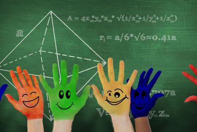 Composite image of hands with colourful smiley faces