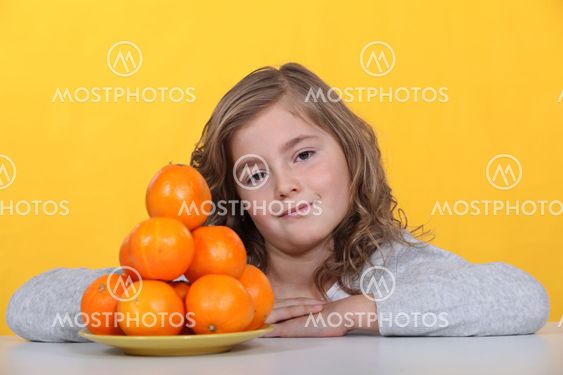 Girl with a pyramid of oranges