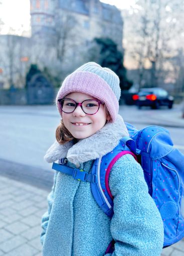 Cute little girl o the way to or from school. Healthy...