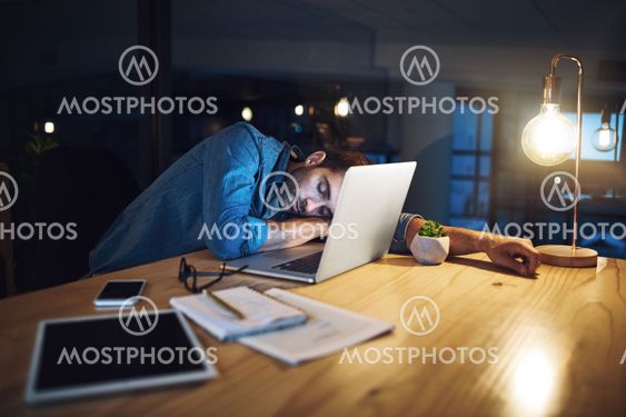 Man, sleeping and fatigue at night in office with laptop,...