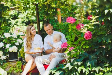 Mom and dad in nature with their one-year-old son...