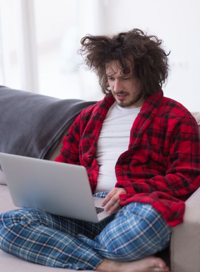 man freelancer in bathrobe working from home