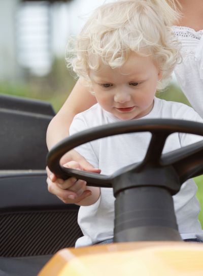 Young Boy Holding Steering Wheel