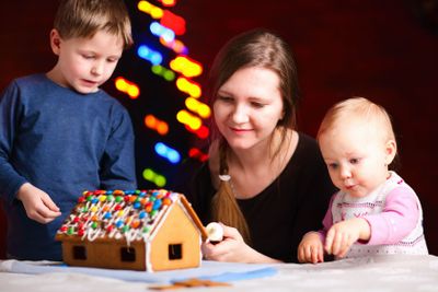 Family making gingerbread house