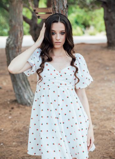 Beautiful slim brunette woman in summer white dress...