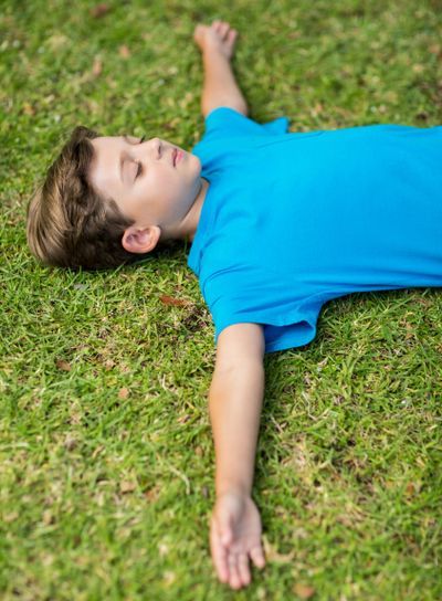 Young boy sleeping in park